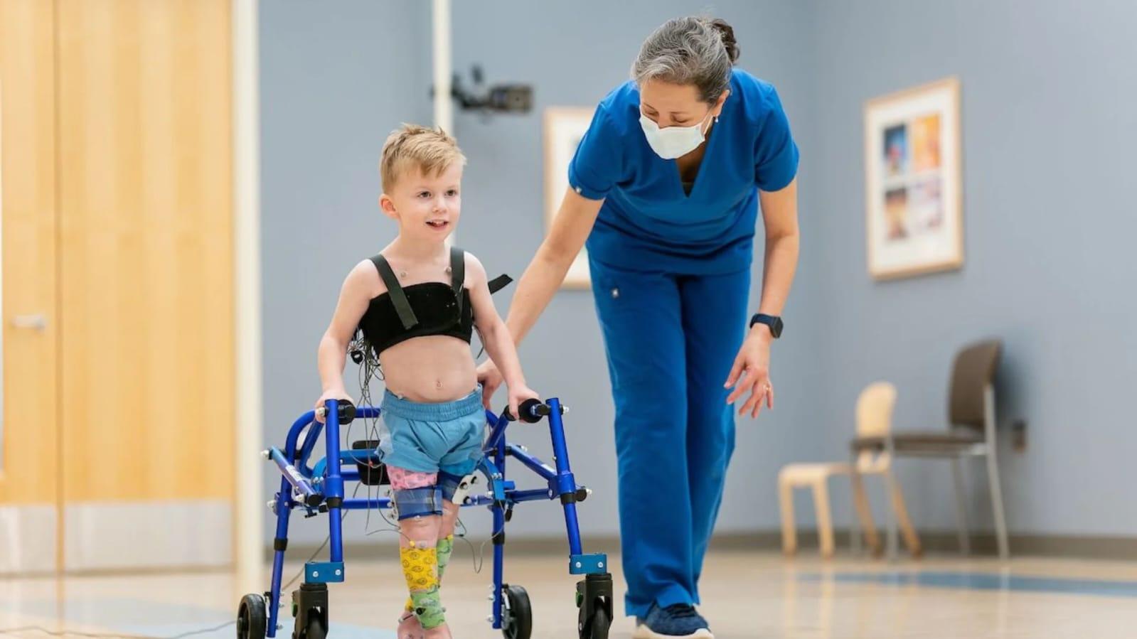 Physiotherapist providing pediatric physiotherapy exercises for a child at home